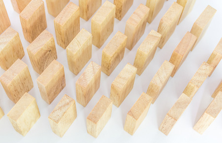 Row wooden domino against the white background