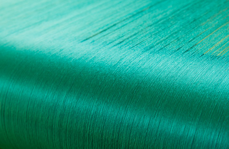 Green silk on a warping loom of a textile mill, Silk for weaving on a hand loomの写真素材