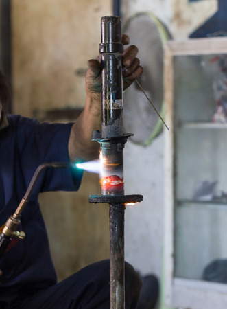 Welders were repairing cutting Shock absorbers of a car in workshopの写真素材