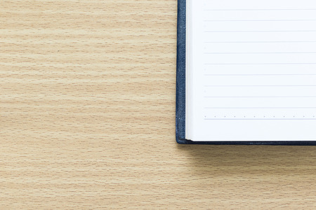 Open notebook with blank page on wood tableの写真素材