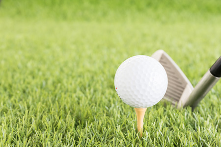 Golf ball sitting on tee putting in golf course. Golf ball on tee ready to be shotの写真素材