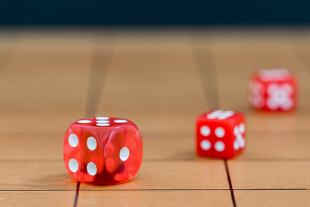 Red dices on wood board, Gambling is illegal.