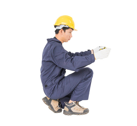 Young worker in unifrom with tape measure isolated on white background cutoutの写真素材