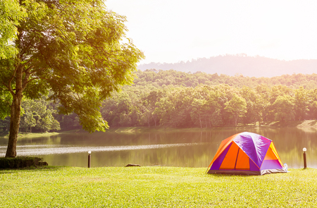 Tourist dome tent camping at lake side  in forest camping siteの写真素材
