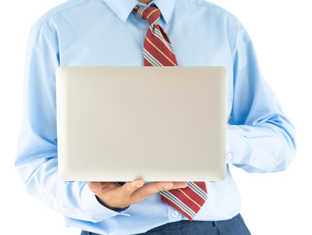 Businessman holding a laptop over white backgroundの写真素材