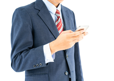 Businessman in suit holding a smartphone over white backgroundの写真素材
