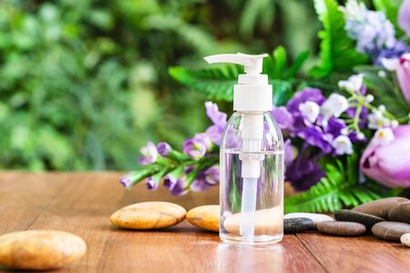 Bottle essential oil for spa massage with flower backgroundの写真素材