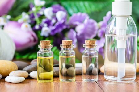 Bottle essential oil for spa massage with flower background