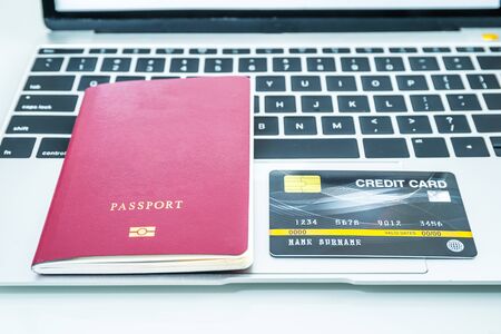 Passport, credit card on keyboard, Traveling conceptの写真素材