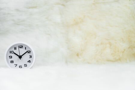 Close up white alarm clock on table,  Minimalism concept