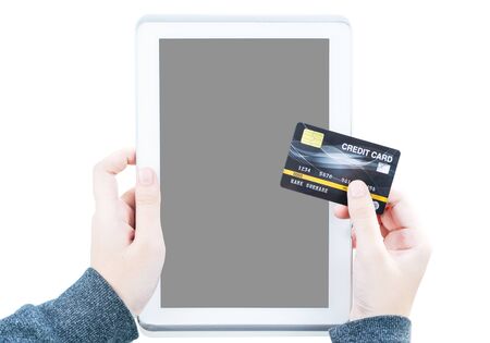 Close up of Female hand hold credit card with tablet computer blank copy space screen  ,Online Travel Booking Conceptの写真素材