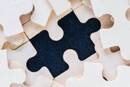 Shot of wooden jigsaw puzzle pieces on black background,Business concept