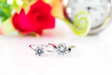Close up Diamond gem wedding rings with watch on white  background, Jewelry wedding diamond rings on white backgroundの写真素材