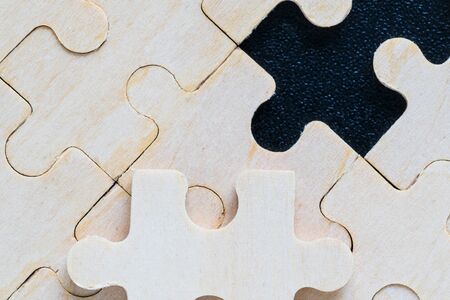 Shot of wooden jigsaw puzzle pieces on black background,Business conceptの写真素材