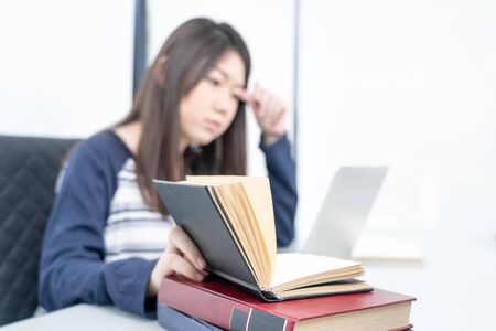 Young female long hair sitting in living room and learning online using laptop at desk .E-learning...