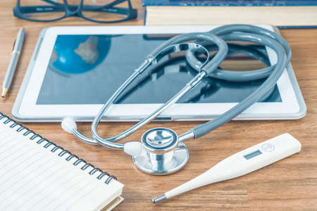 Medical stethoscope for doctor checkup on notepad as medical concept
