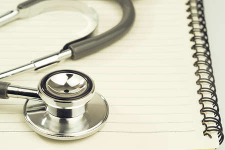 Close up Medical stethoscope with blank notepad as medical conceptの写真素材