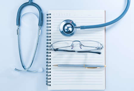 Close up Medical stethoscope with blank notepad as medical concept
