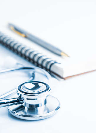 Close up Medical stethoscope with blank notepad as medical conceptの写真素材