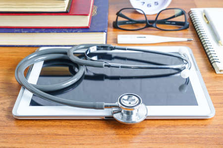 Close up Medical stethoscope with blank notepad as medical conceptの写真素材