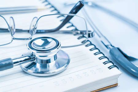 Close up Medical stethoscope with blank notepad as medical conceptの写真素材