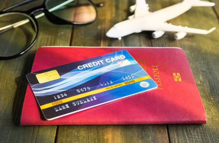 Credit card put on passport on wooden desk , Preparation for Traveling conceptの写真素材
