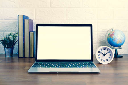 Blank screen laptop computer on deck, Workplace with laptop on table at home,Work form home conceptの写真素材