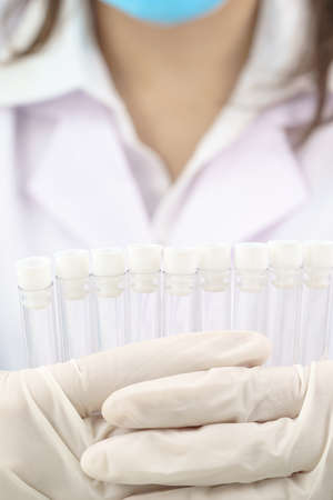 Technician scientist analyzing holding test tube in laboratoryの写真素材