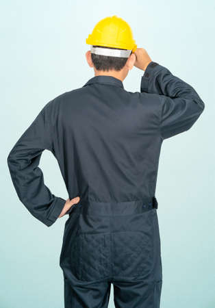 Young man wearing helmet isolated on blueの写真素材