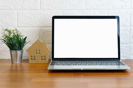 Blank screen laptop computer on deck, Workplace with laptop on table at home,Work form home conceptの写真素材