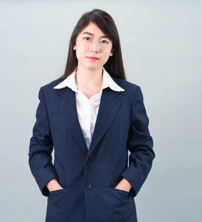 Portrait of asian businesswoman isolated on gray backgroundの写真素材