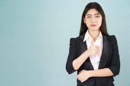 Asian business women in suit and thump up hand signの写真素材