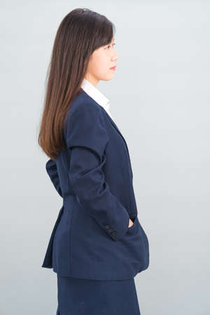 Portrait of asian businesswoman isolated on gray backgroundの写真素材