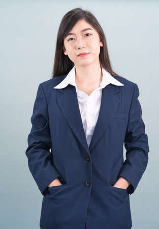 Portrait of asian businesswoman isolated on gray backgroundの写真素材