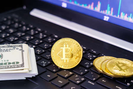 Bitcoins coin and banknotes on keyboard computer. Close up of  bitcoin crypto currency coins with...