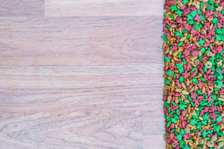 Top view dry cat food on wooden background with copy spaceの写真素材