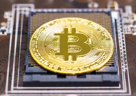 Cryptocurrency bitcoin coins on circuit board. Blockchain technology bitcoin mining conceptの写真素材