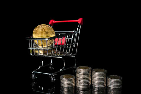 Close up Bitcoin coin in shopping cart on black backgroundの写真素材