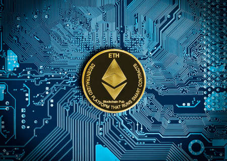 Close up ethereum coin on blue circuit mainboard of computer backgroundの写真素材
