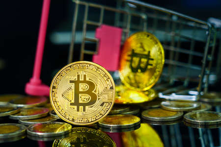 Close up Bitcoin coin in shopping cart on black backgroundの写真素材