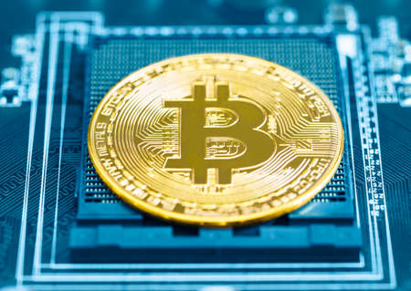 Cryptocurrency bitcoin coins on circuit board. Blockchain technology bitcoin mining conceptの写真素材