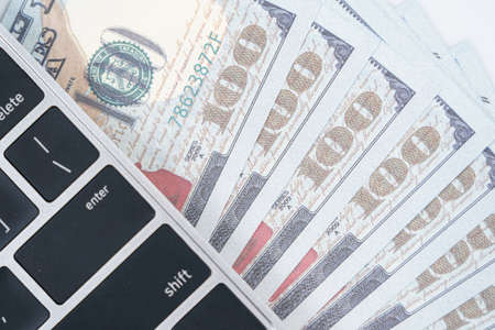 US banknotes and keyboard computer with eyeglasseの写真素材