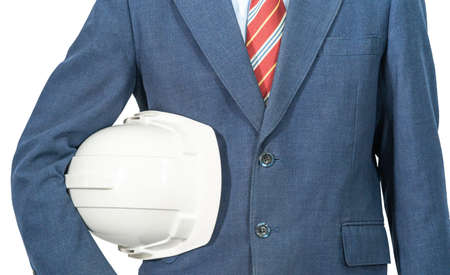 Cloes up man standing in blue suit holding white hardhat isolated on white backgroundの写真素材