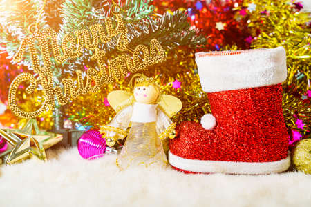 Red Santa claus boot and chrismas doll with Christmas ornaments and decorationsの写真素材