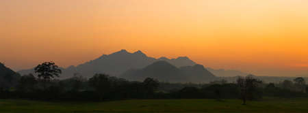 landscape mountain with golden sky hours in the morning sunrise in twilight timeの写真素材