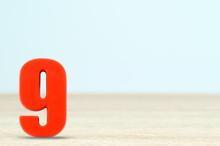 Shot of a number nine made of red plastic on table with copy spaceの写真素材