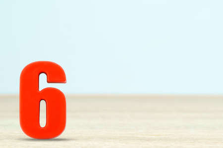 Shot of a number six made of red plastic on table with copy spaceの写真素材
