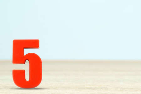 Shot of a number five made of red plastic on table with copy spaceの写真素材