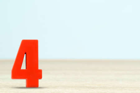 Shot of a number four made of red plastic on table with copy spaceの写真素材