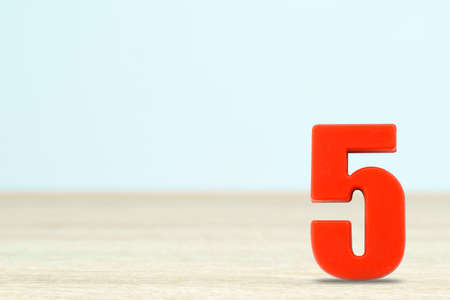Shot of a number five made of red plastic on table with copy spaceの写真素材